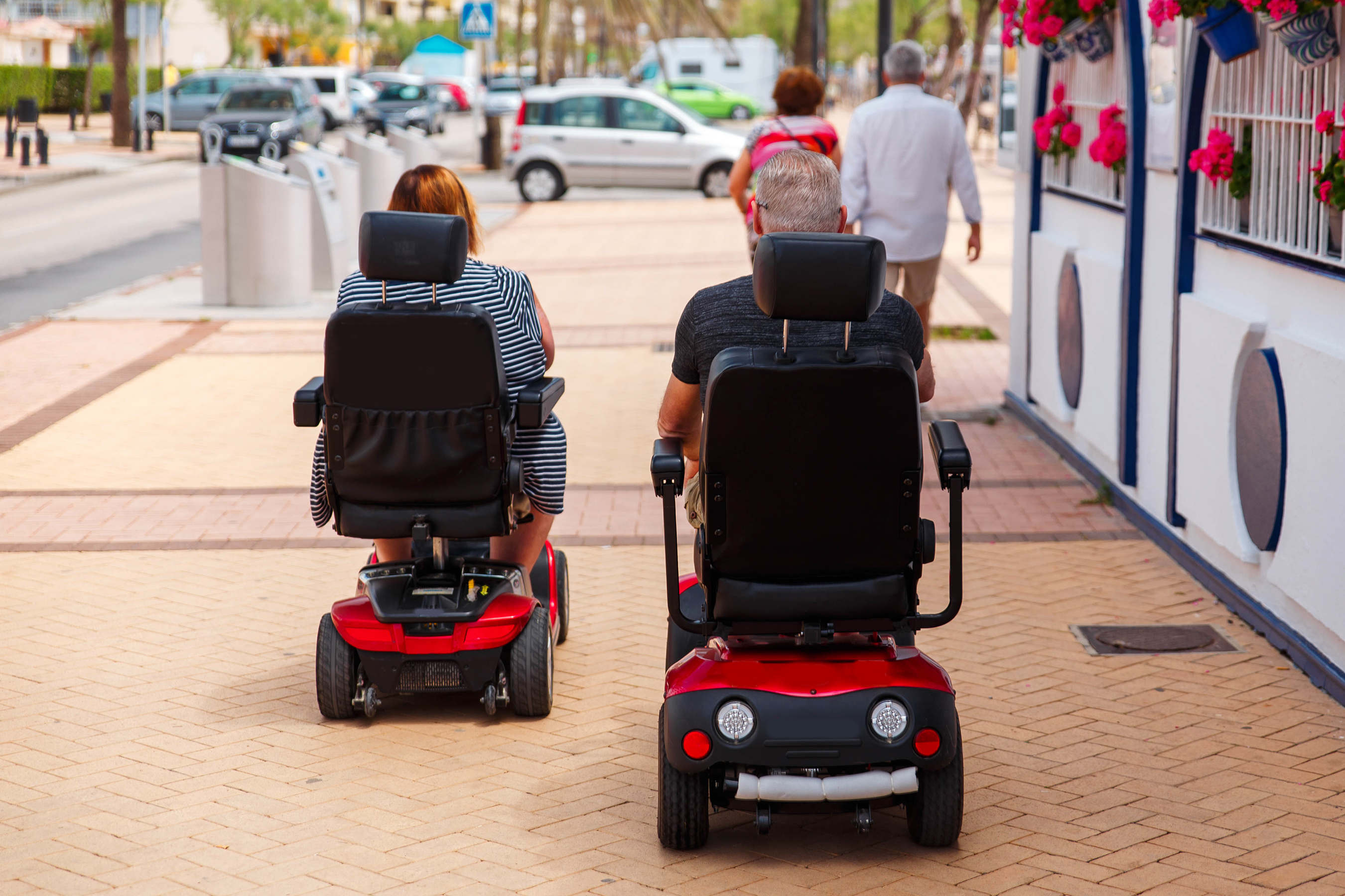 Man And Woman On A Powerchairs